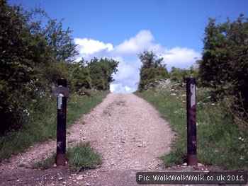 Stone-surfaced uphill cycle path between posts Stone-surfaced uphill cycle path between posts