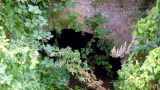 The Brook disappears under the railway embankment