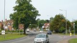 Head up the road and prepare to cross after the first houses